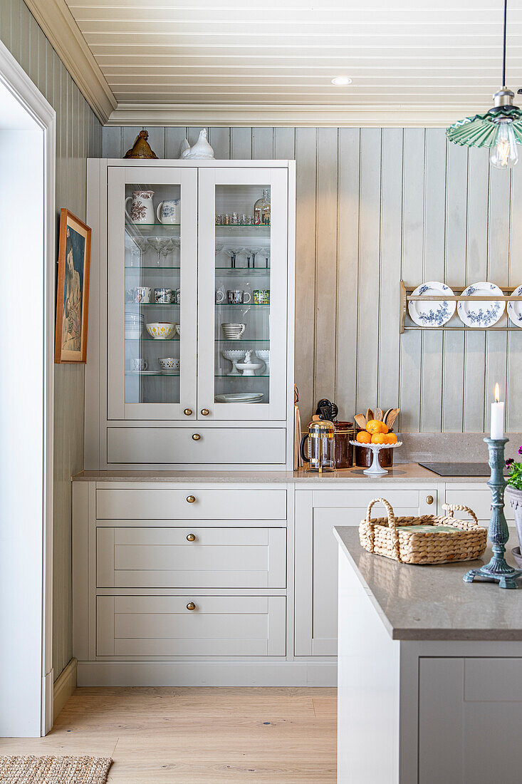 Country-style kitchen with display cabinet and wood panelling