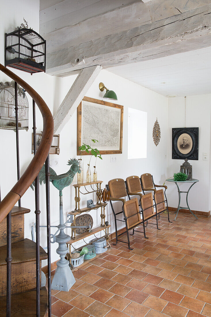 Seating area in the hallway with wooden chairs and antique decorative elements