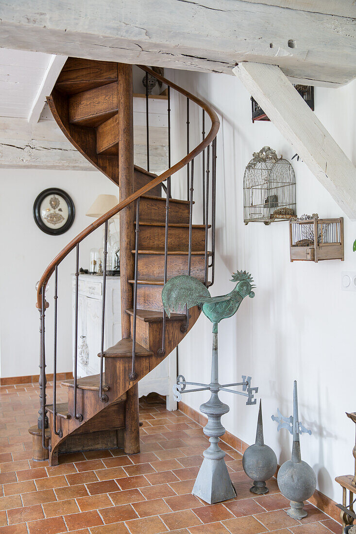 Wooden spiral staircase with decorative elements in country house style