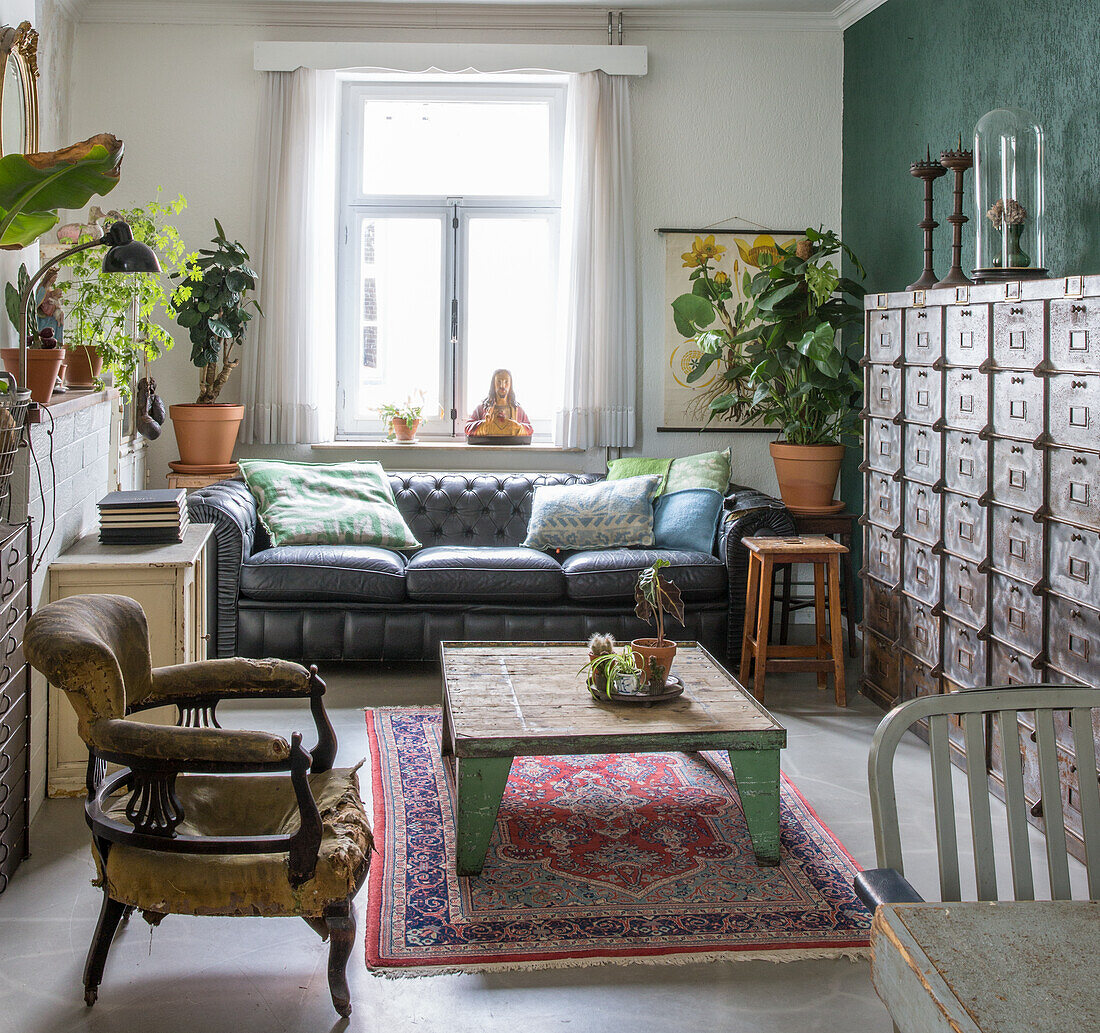 Living room with antique furniture, leather sofa and vintage cupboards