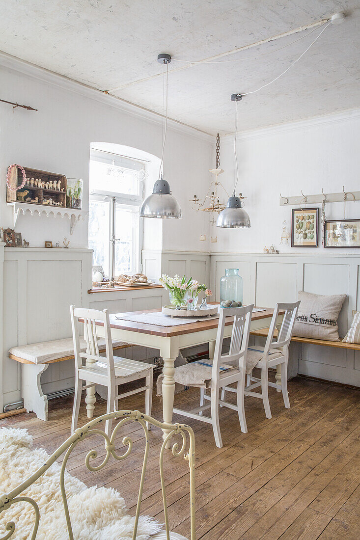 Country-style dining room with wooden floor and metal lamps