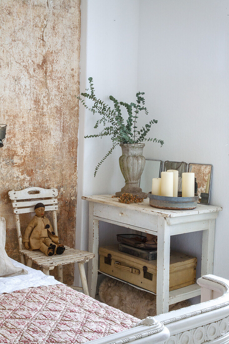 Nostalgic room corner with vintage furniture, eucalyptus bouquet and decorative elements