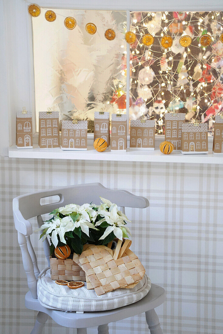 Christmas decoration with garland made from dried orange slices, paper houses and lights