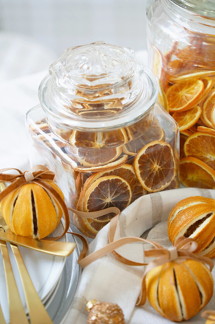 Glass jars with dried orange slices and decorative dried oranges