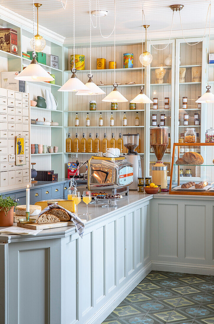 Country-style kitchen with blue cupboards and retro coffee machine