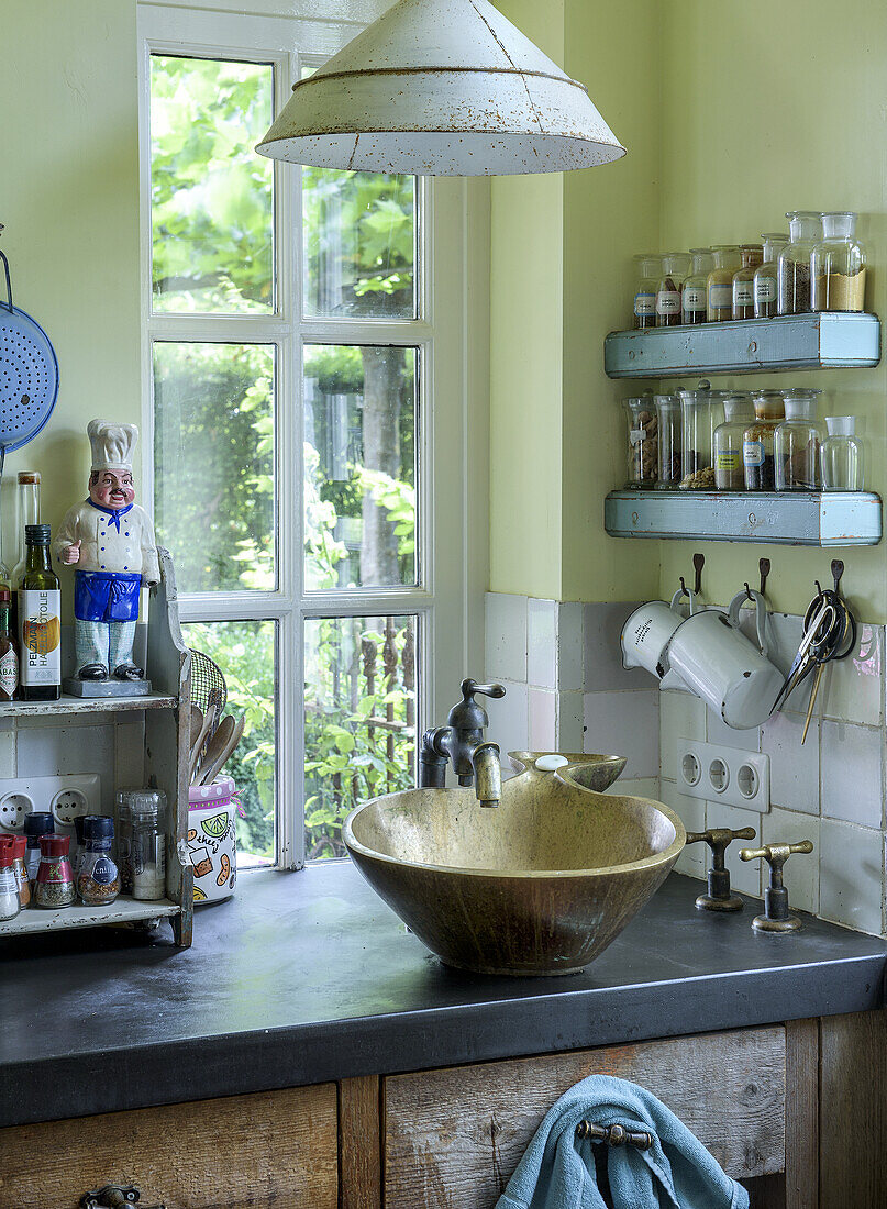 Country-style kitchen with unusual sink and spice racks by the window