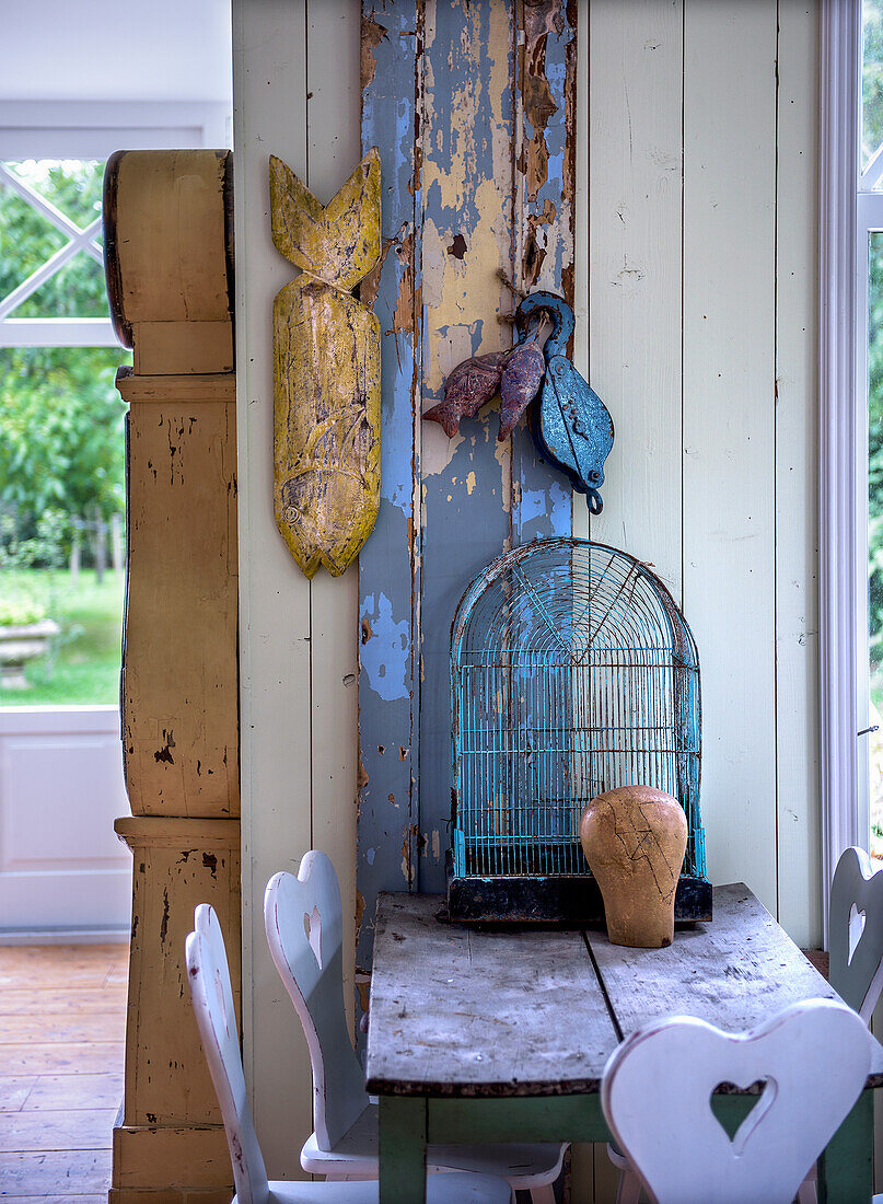 Rustic table with birdcage and traditional farmhouse chairs with hearts