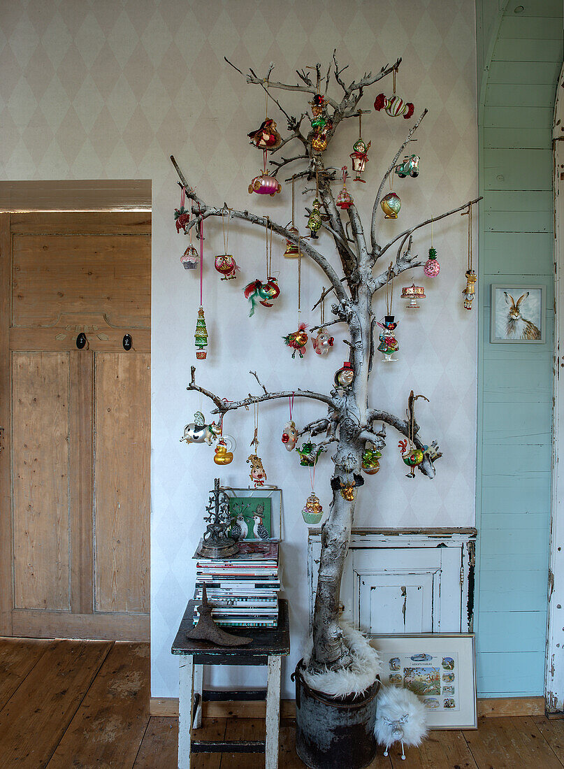 Christmas tree made from birch branches with colourful vintage pendants