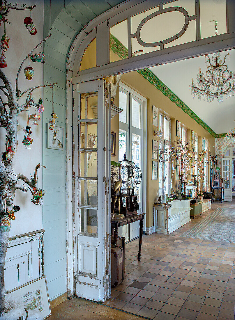 Hallway with antique furniture and decorative chandeliers