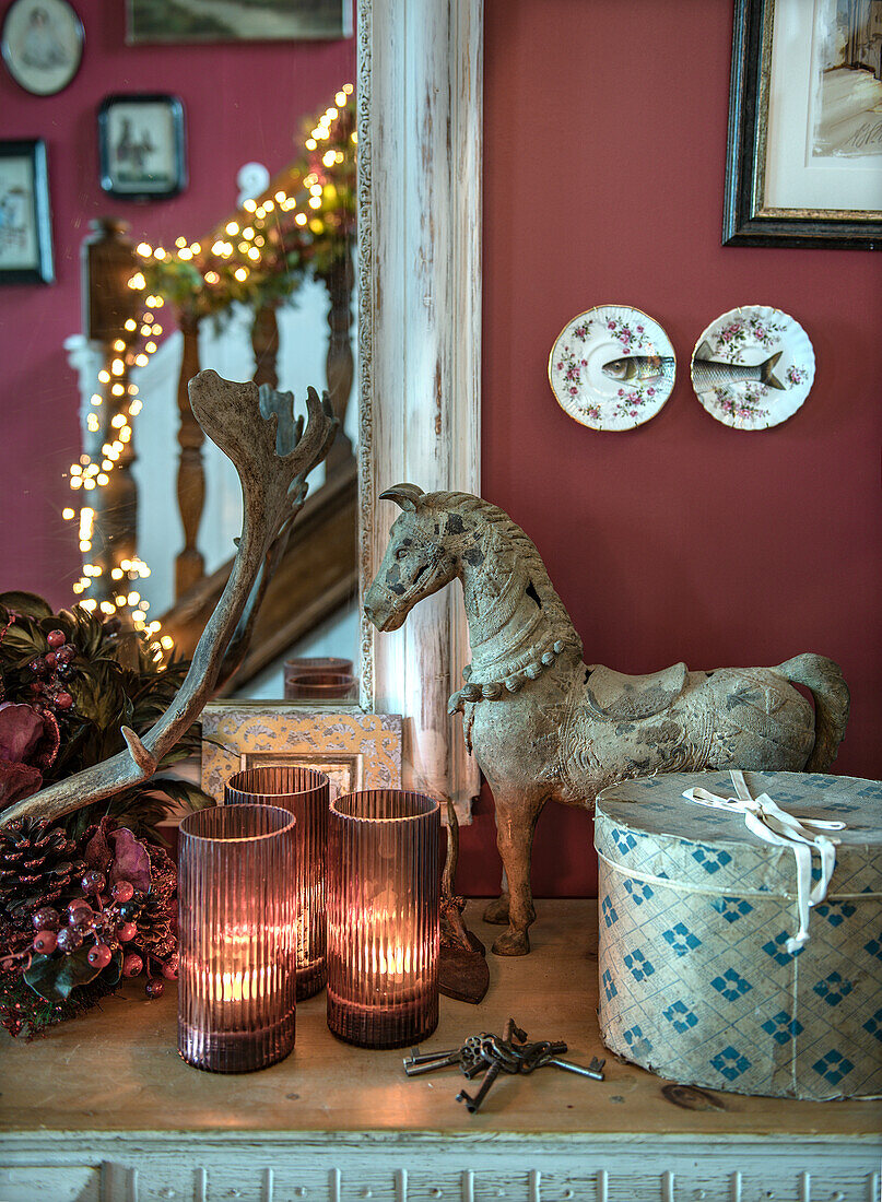 Vintage decorations with wooden horse, candles and hatbox