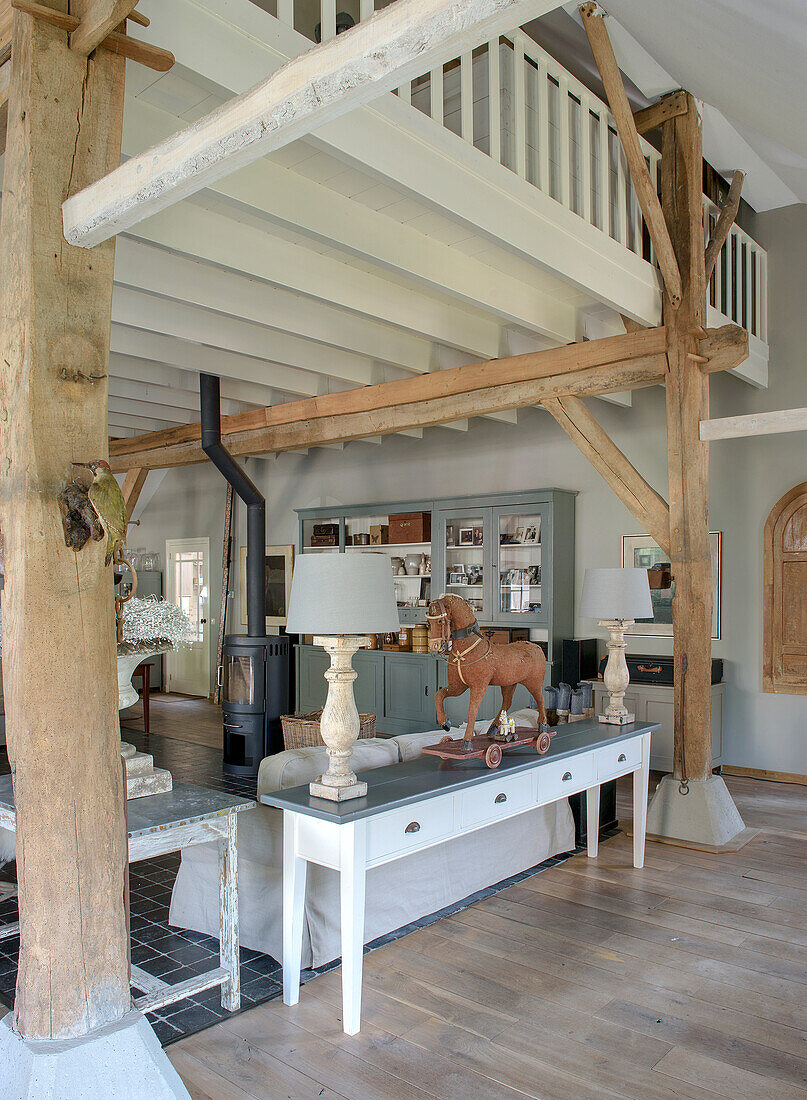 Living room with exposed wooden beams and Scandinavian-style furniture