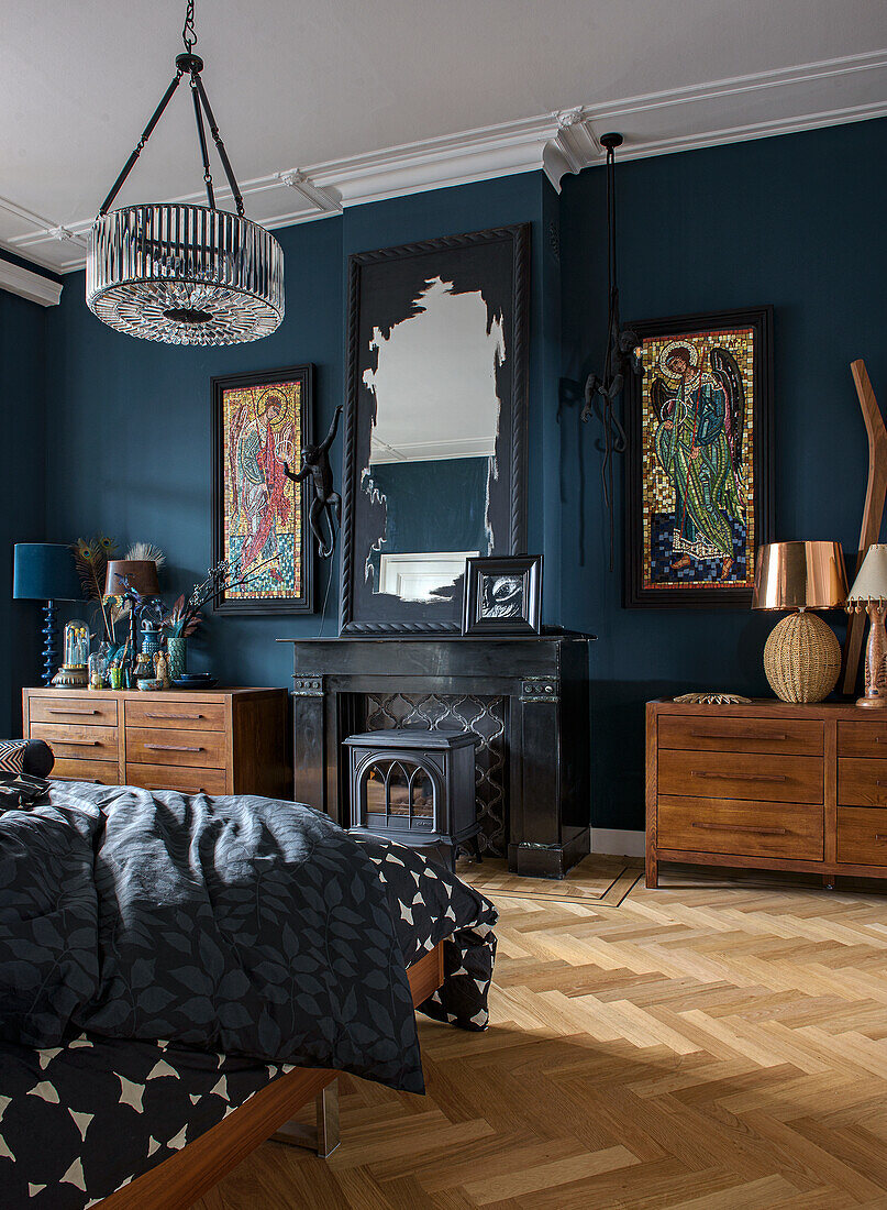 Bedroom with dark blue walls, fireplace and parquet flooring