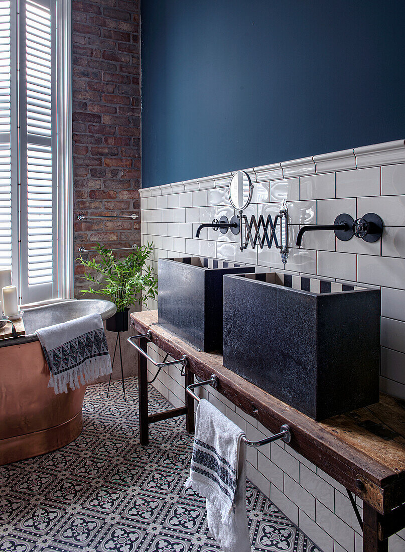 Modern bathroom with patterned floor tiles and brick wall