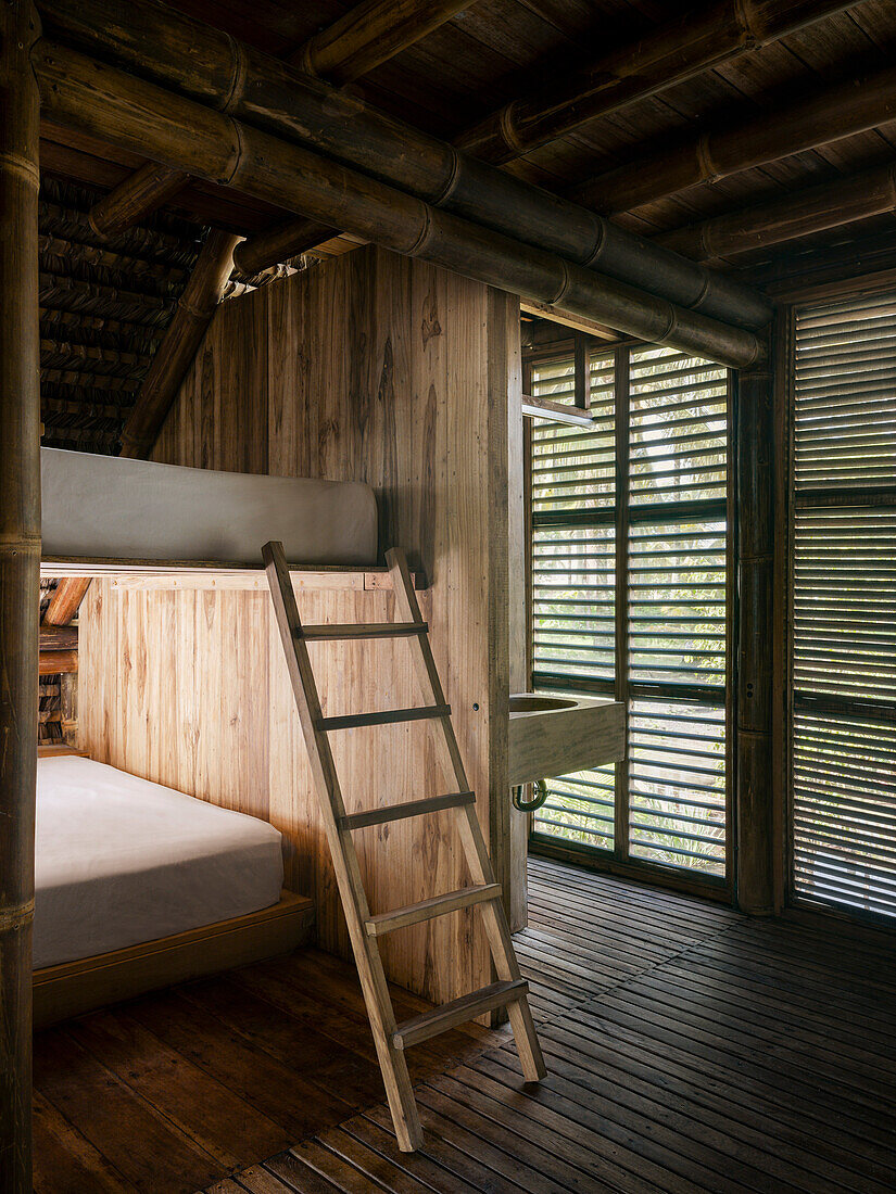 Bedroom with bunk beds, bamboo construction and wood panelling