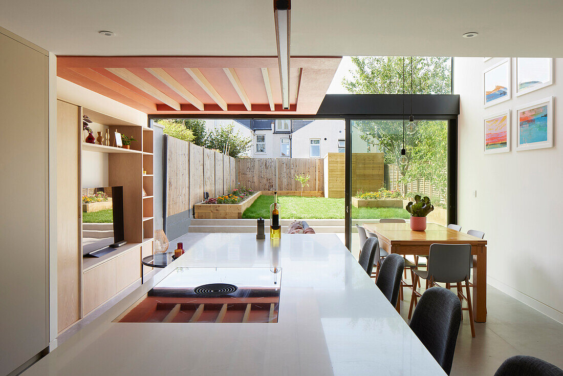Open-plan kitchen with garden view, contemporary wooden ceiling, Great Britain