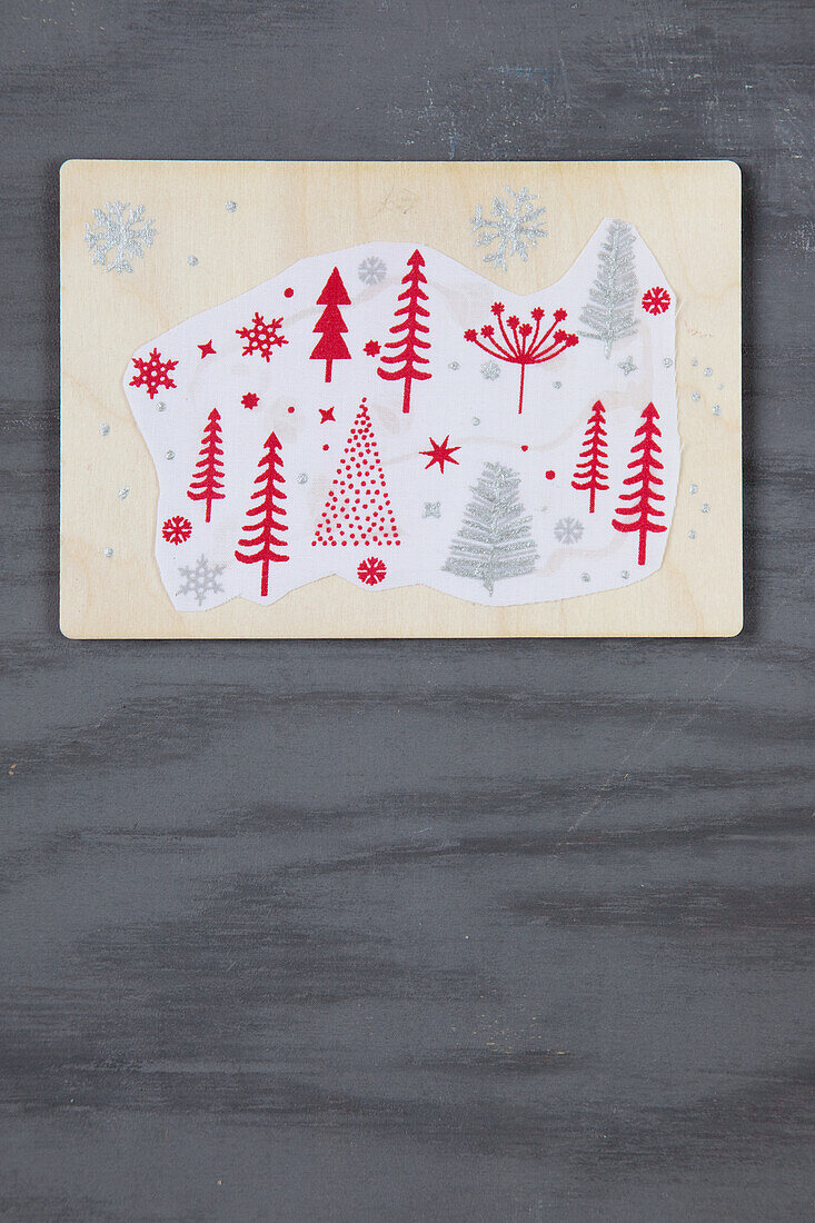 Wooden board with Christmas tree motif on a dark background