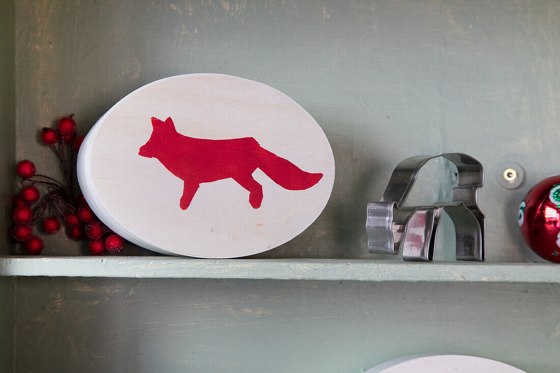 Decorative wooden sign with red fox on grey shelf