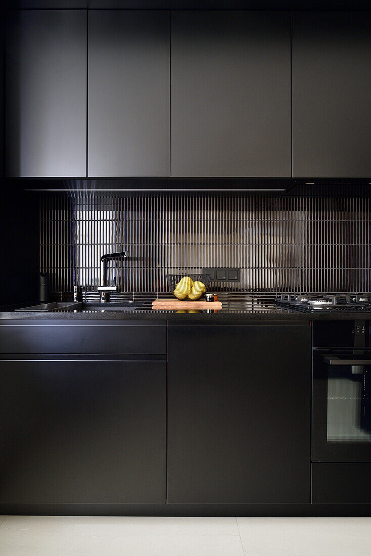 Modern kitchen in black with built-in appliances