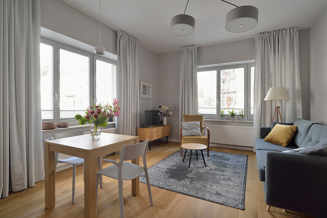 Bright living room with dining area in a flat in Nowa Praga, Warsaw