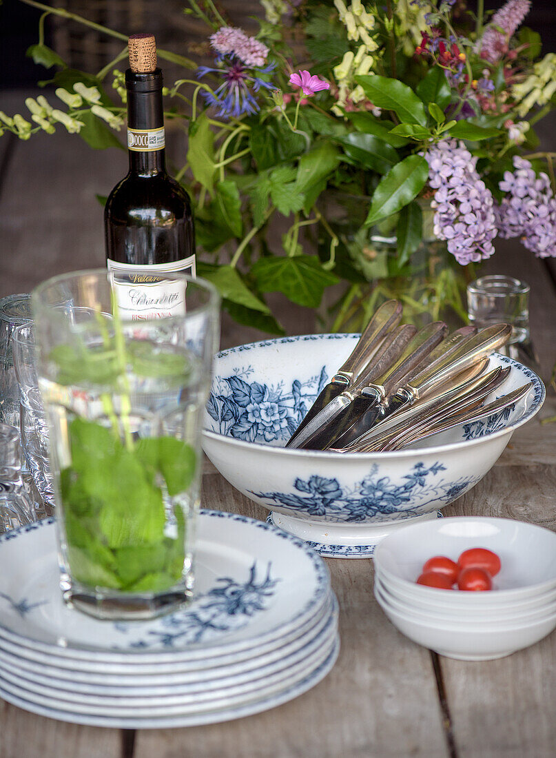 Laid table with blue and white china, cutlery and flowers