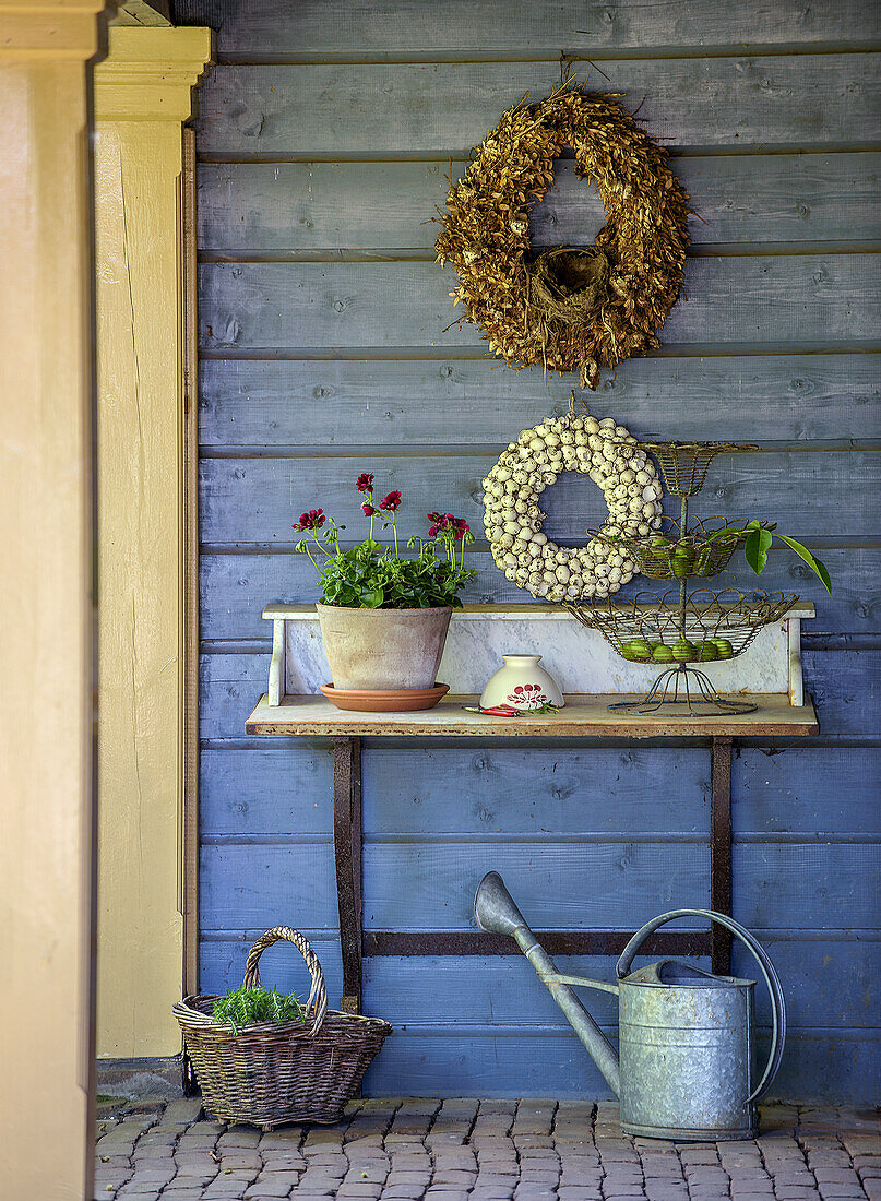 Entrance area decorated in autumn with wreaths and plants