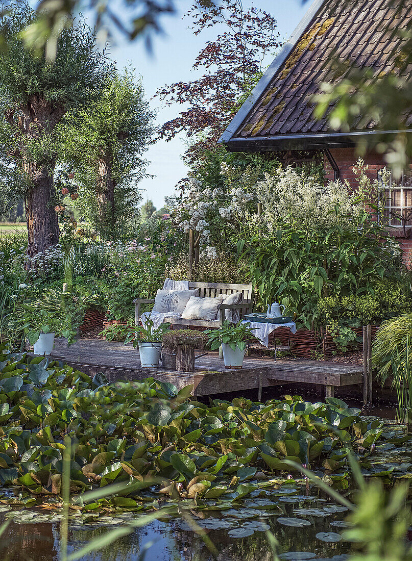 Romantic bench on wooden deck by the pond