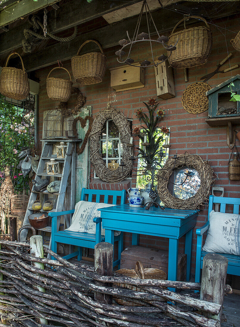 Rustic patio area with blue wooden furniture and woven baskets