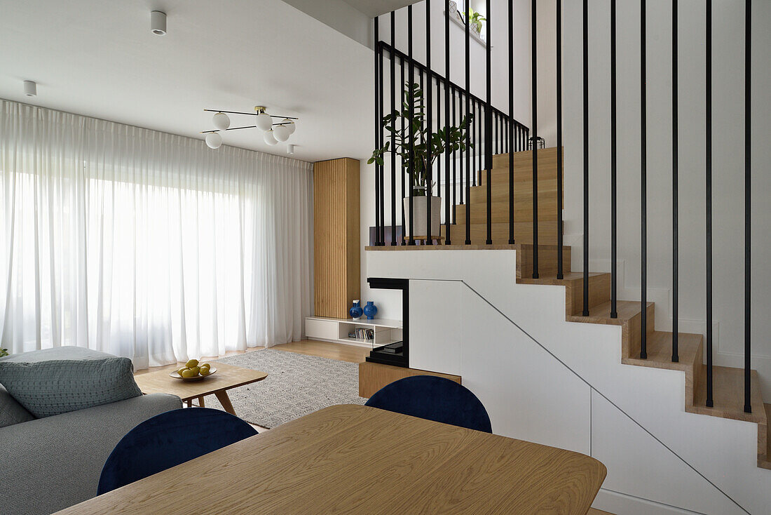 Modern living room with staircase and wooden elements