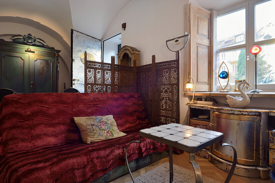 Living room with red velvet sofa and period furniture