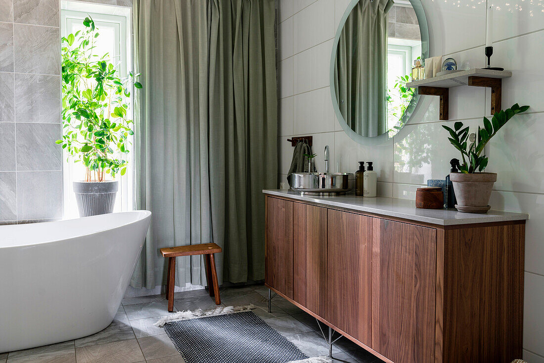 Modern bathroom with free-standing bathtub and wooden furniture