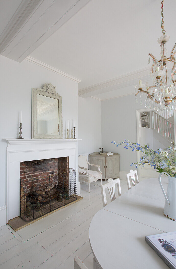 Bright room with fireplace, dining table and chandelier