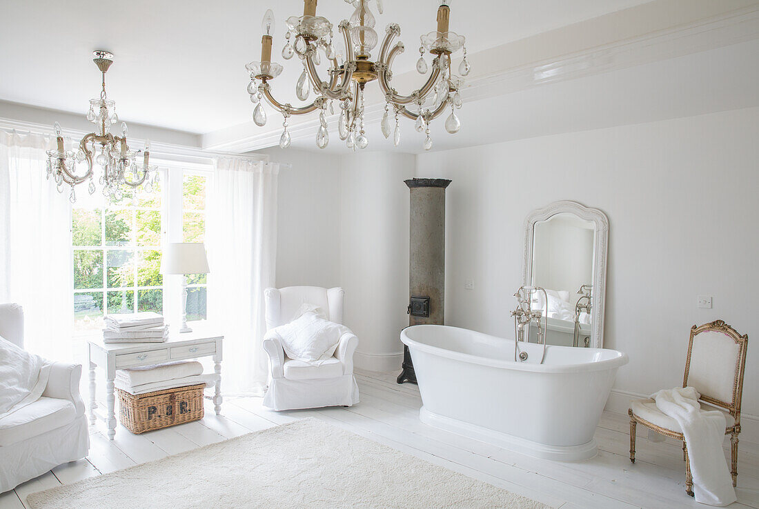 Bright bathroom with freestanding bathtub and chandelier