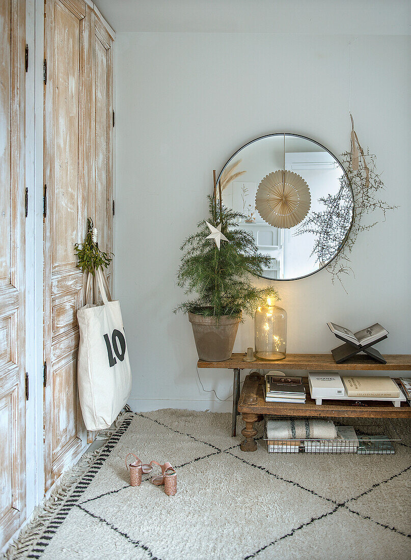 Room with round mirror and rustic cabinet