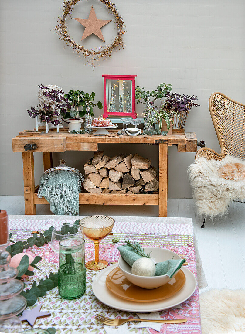 Dining area with festively laid table and workbench with logs