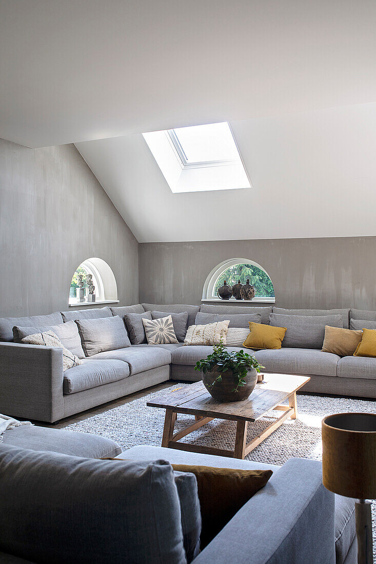 Living room in white and grey with skylight and corner sofa