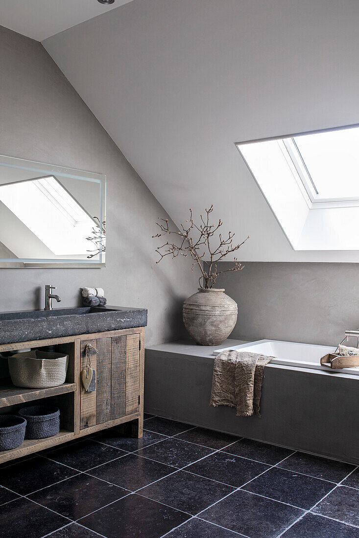 Bathroom with skylight, stone tiled floor and rustic washbasin