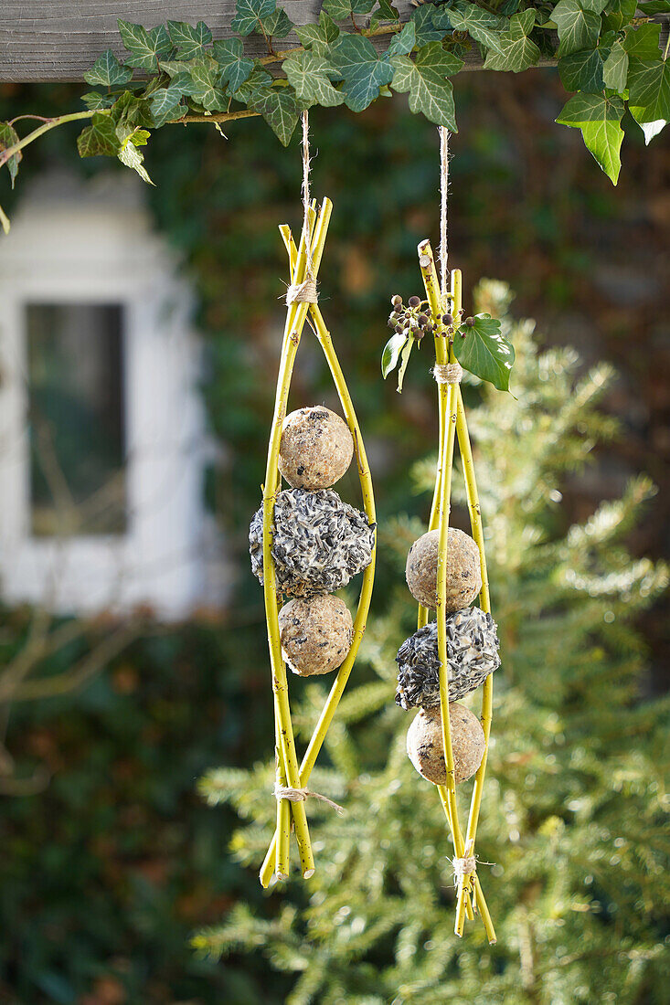 Homemade bird feeder made from willow branches in the garden