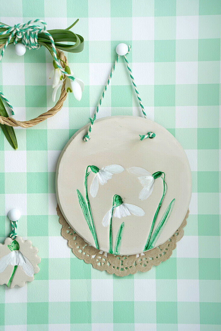 Handmade wall decoration with snowdrop motif and lace coaster