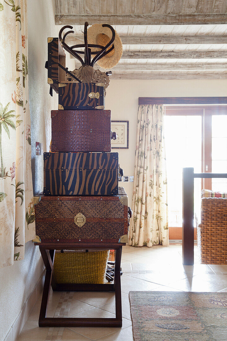 Stacked vintage chests with different patterns in living room corner