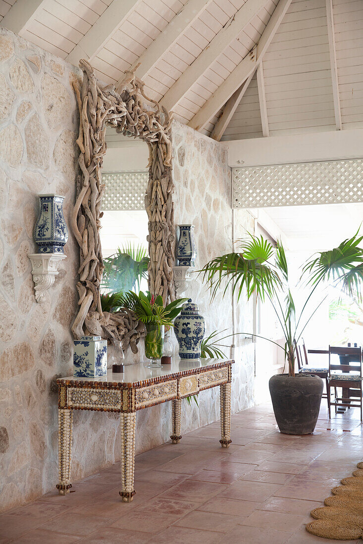 Entrance area with driftwood mirror frame and blue and white porcelain vases