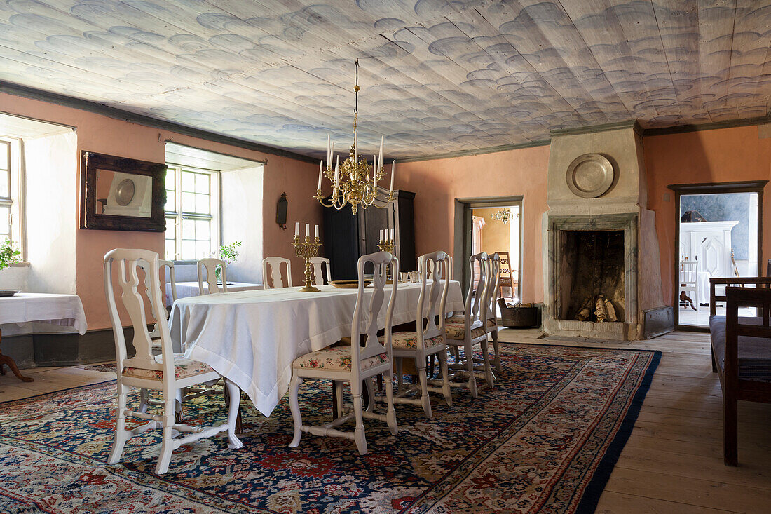 Dining room with historic charm, oriental carpet and antique fireplace