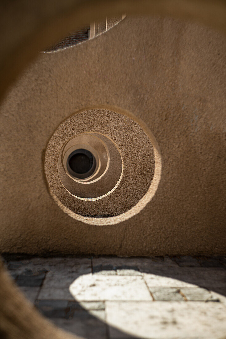 View through several holes in the wall with play of light and shadow