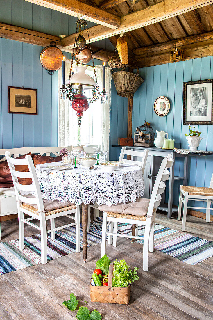 Country-style dining area with blue-painted wooden walls and rustic details