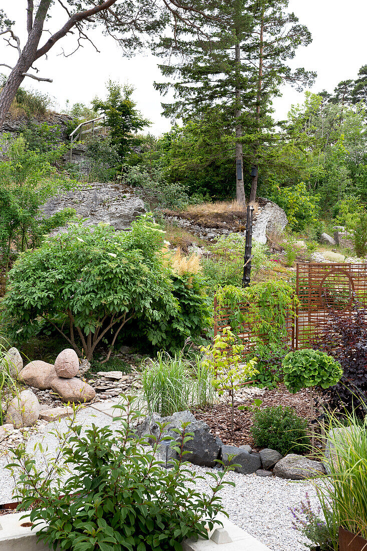 Zen garden with natural stones and gravel paths on a slope