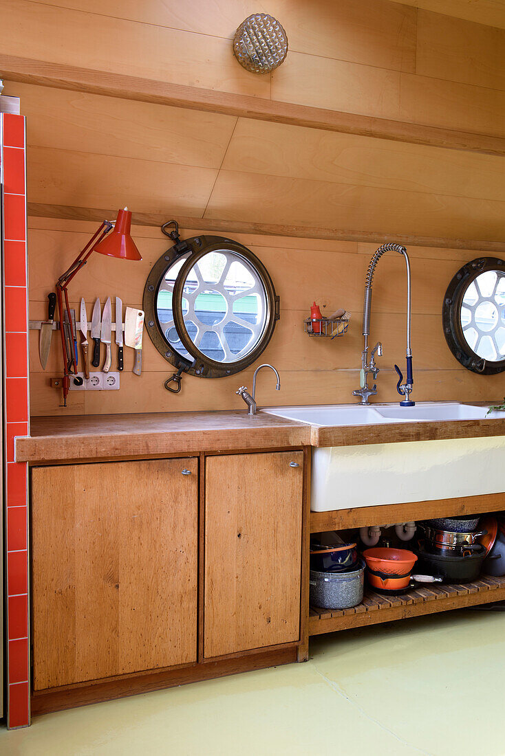 Kitchen area with porthole windows and sink