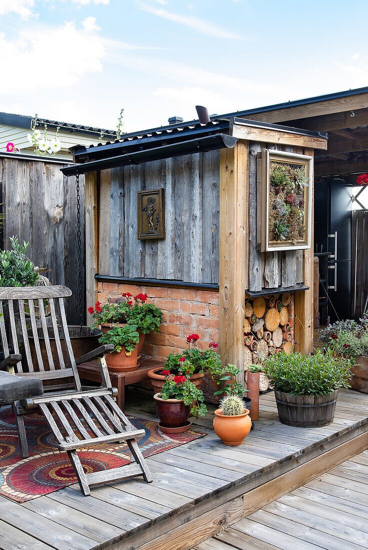 Potted plants, deckchair and wood storage on the terrace