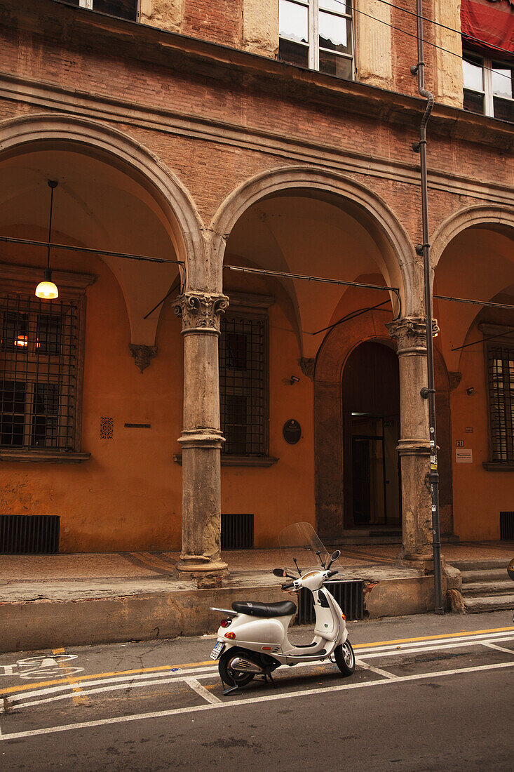 White Vespa in front of a house in Bologna