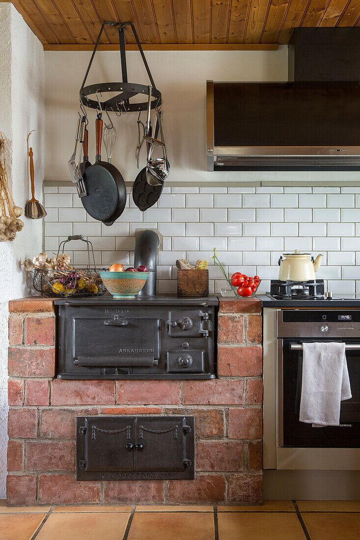 Kitchenette with kitchen utensils and traditional wood-burning stove