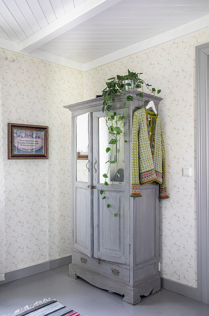 Antique cupboard decorated with ivy