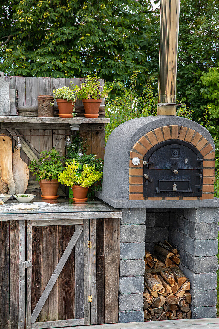 Stone oven and plant pots in a rustic garden setting